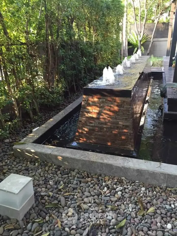 Serene garden with elegant water feature and lush greenery