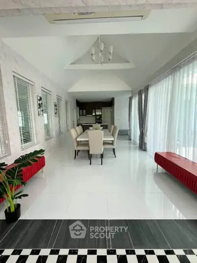 Spacious modern living room with elegant dining area and large windows