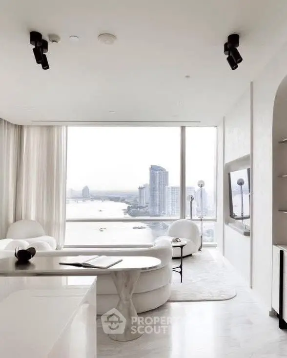 Luxurious modern living room with stunning city and river view, elegant white decor and large windows.