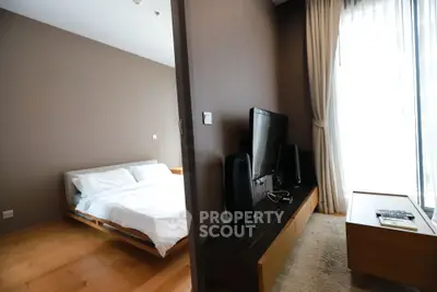 Modern bedroom and living area with sleek design and natural light