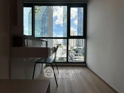 Modern study area with city view, featuring sleek desk and chair, ideal for productivity.