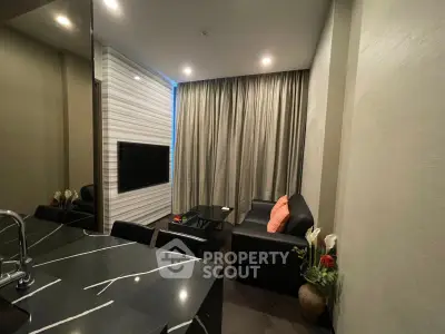 Modern living room with sleek black furniture and elegant decor, perfect for urban living.