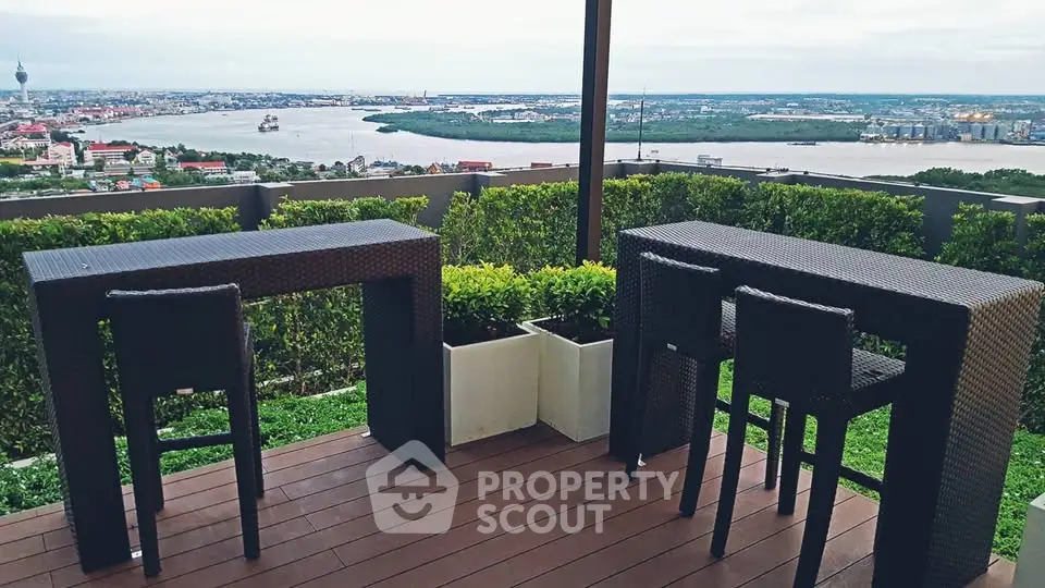 Stunning rooftop terrace with panoramic river view and modern outdoor furniture.
