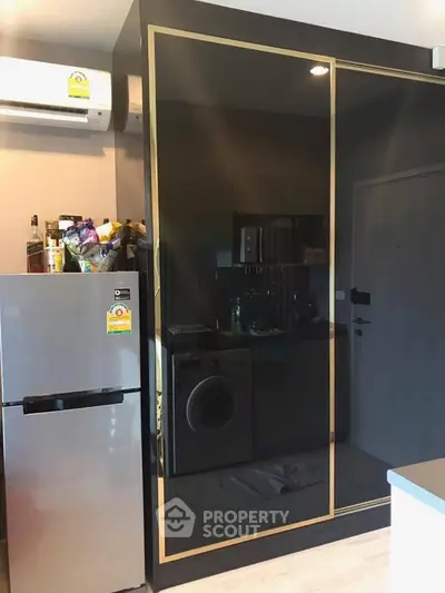 Modern kitchen with sleek black cabinetry and built-in washing machine