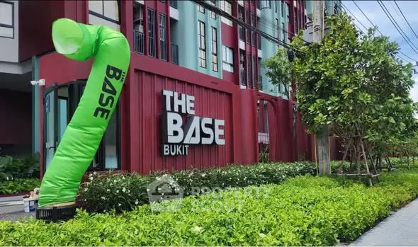 Modern apartment building exterior with lush greenery at The Base Bukit.