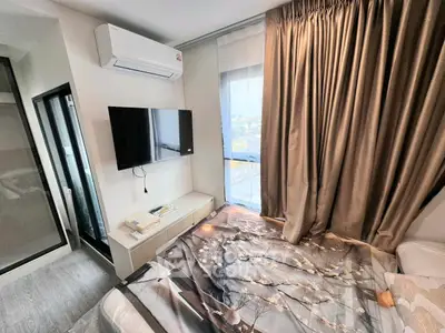 Modern bedroom with stylish decor, featuring a wall-mounted TV and air conditioning for comfort.