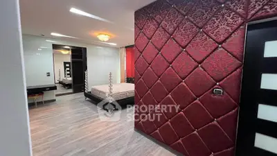 Luxurious bedroom with elegant red accent wall and modern decor