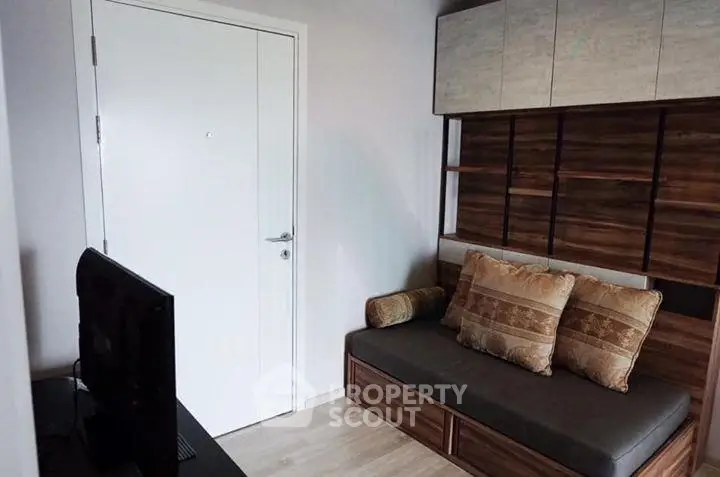 Cozy living room with modern sofa and TV setup, perfect for relaxation.