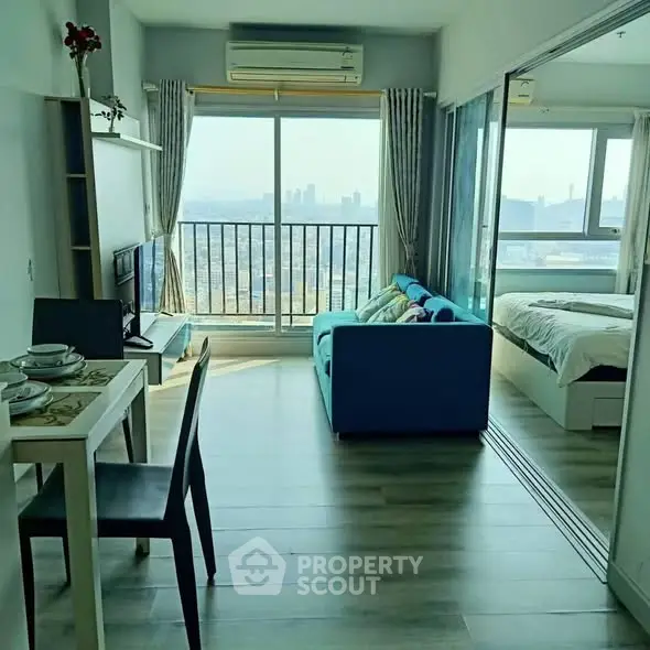 Modern apartment with stunning city view, featuring open living area and cozy bedroom.
