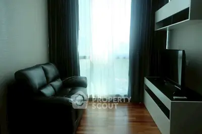 Cozy living room with leather sofa and modern entertainment unit
