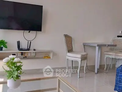 Modern living room with wall-mounted TV and elegant furniture