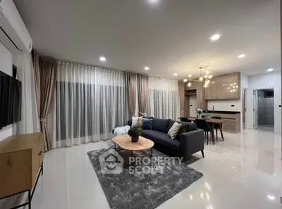 Spacious modern living room with elegant decor and open kitchen layout