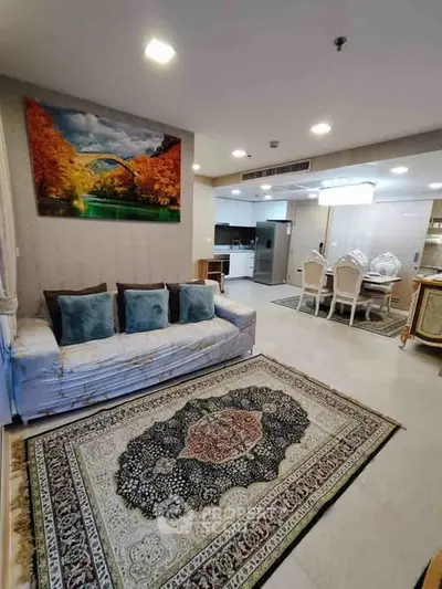 Spacious living room with elegant decor and open kitchen layout in modern apartment.