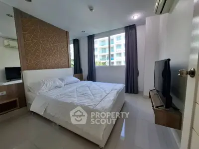 Modern bedroom with large window and stylish decor in a luxury apartment.