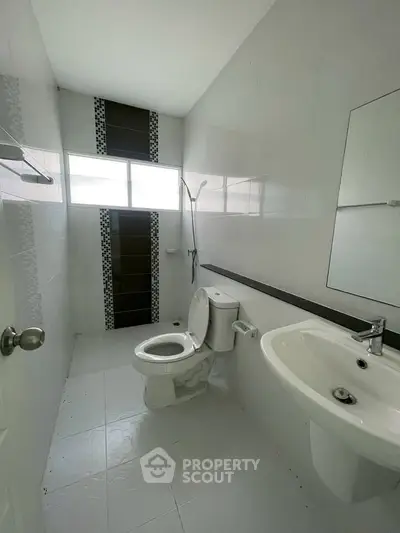 Modern bathroom with sleek white tiles and contemporary fixtures