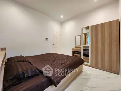 Spacious bedroom with modern furniture and elegant decor