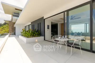 Luxurious modern balcony with stunning ocean view and stylish outdoor seating.