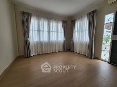 Spacious corner unit with large windows and elegant curtains, perfect for natural light lovers.