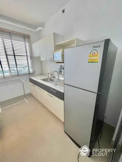 Modern kitchen with sleek appliances and ample natural light