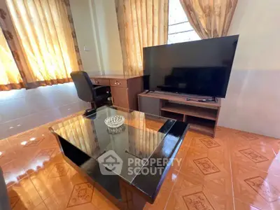 Cozy living room with modern TV setup and elegant curtains