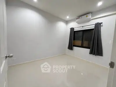 Spacious unfurnished room with air conditioning and tiled flooring