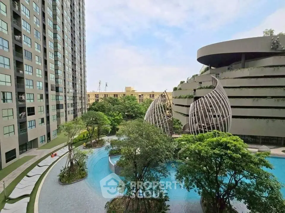 Luxurious residential complex with modern architecture and serene poolside view.