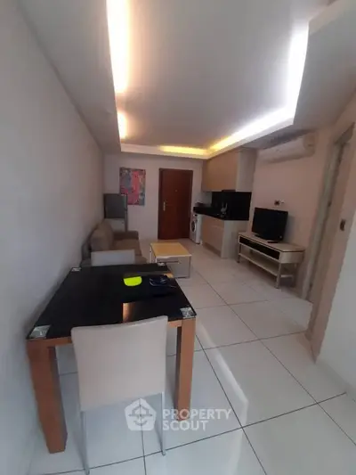 Modern living room with sleek furniture and integrated kitchen appliances