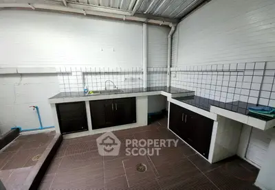 Spacious kitchen with modern tiled countertops and ample storage space