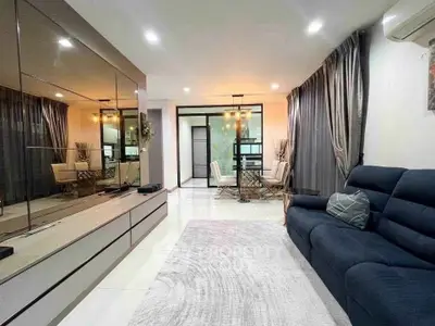 Spacious modern living room with elegant decor and dining area, featuring sleek furniture and ambient lighting.