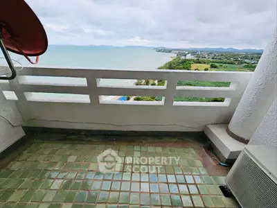 Stunning ocean view from a high-rise balcony with green tiled flooring.