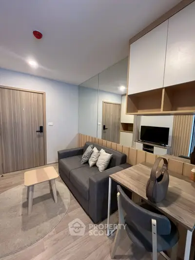 Modern living room with sleek furniture and stylish decor in a cozy apartment setting.