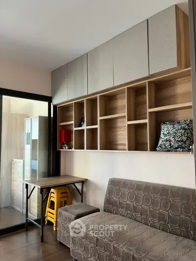 Modern living room with stylish shelving and cozy sofa in contemporary apartment.