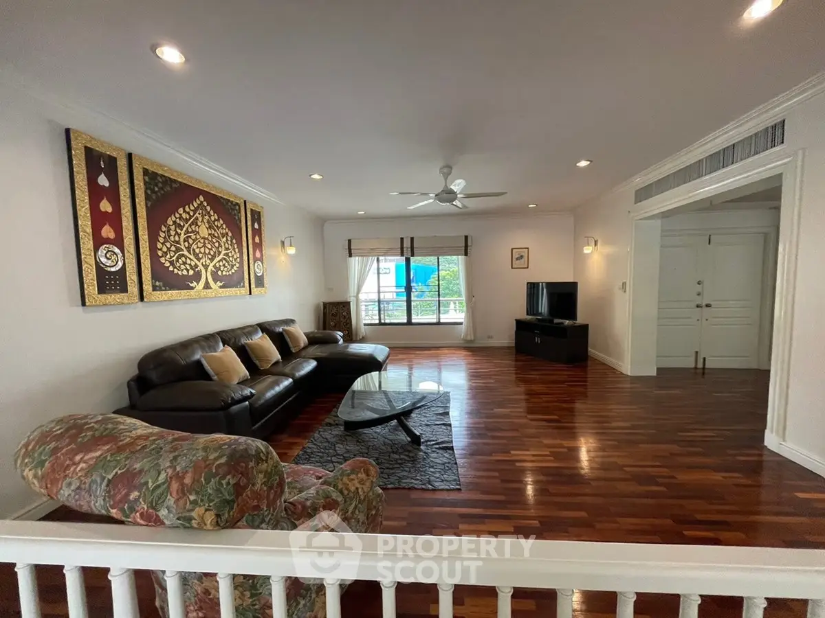 Spacious living room with elegant wooden flooring and stylish decor