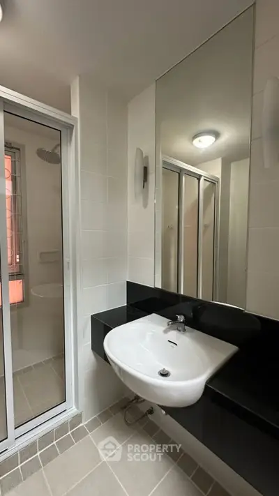 Modern bathroom with sleek sink and glass shower enclosure
