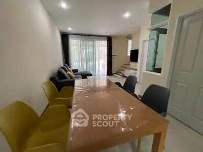 Spacious living room with modern dining area and cozy seating, perfect for family gatherings.