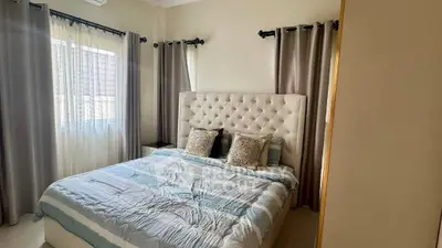 Cozy bedroom with elegant tufted headboard and soft natural lighting.