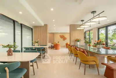 Luxurious open-plan living area with elegant dining setup and vibrant decor, perfect for entertaining.