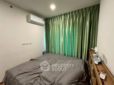 Cozy bedroom with green curtains and modern air conditioning unit