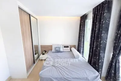 Cozy bedroom with modern design, featuring large windows and stylish curtains.