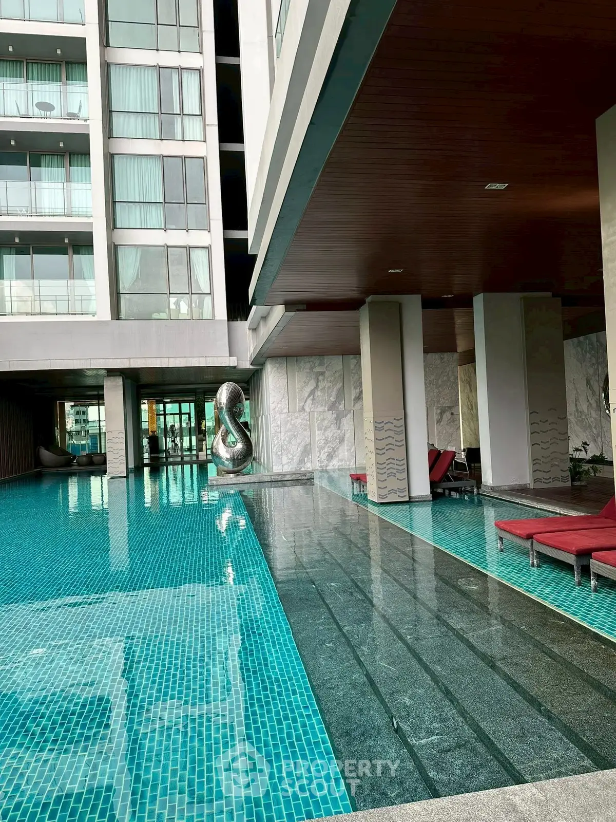 Luxurious modern apartment with stunning poolside view and sleek architectural design.