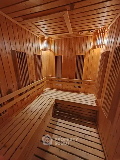 Luxurious wooden sauna with warm lighting and spacious seating