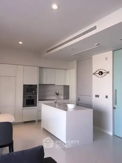 Modern kitchen with sleek white cabinetry and central island