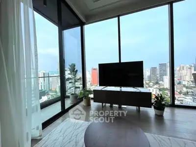 Stunning living room with floor-to-ceiling windows offering panoramic city views and modern decor.