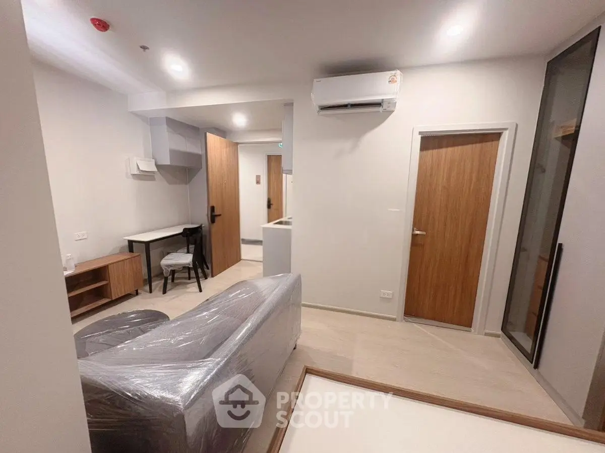 Modern living room with sleek design and air conditioning in a contemporary apartment.