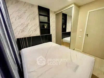 Modern bedroom with stylish decor and mirrored wardrobe