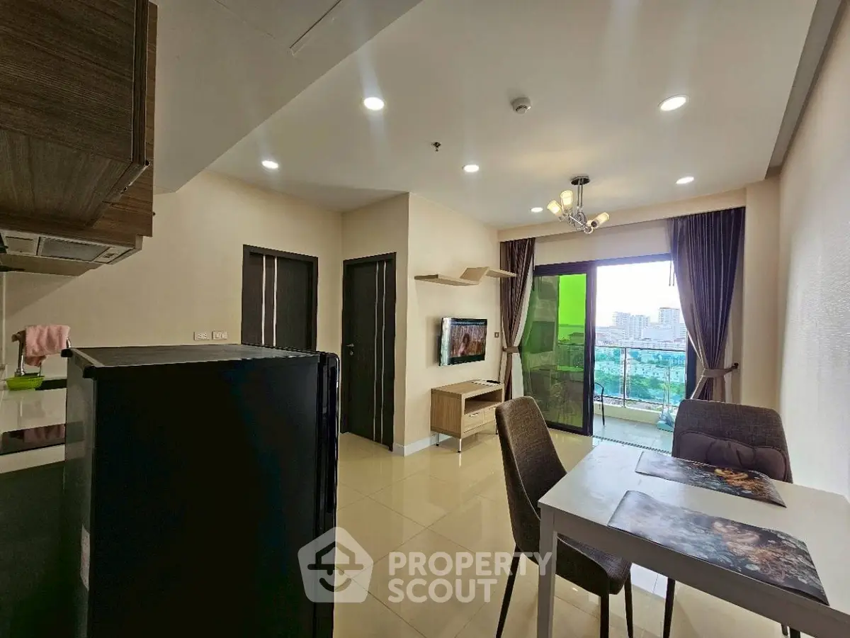 Modern living room with open kitchen and balcony view