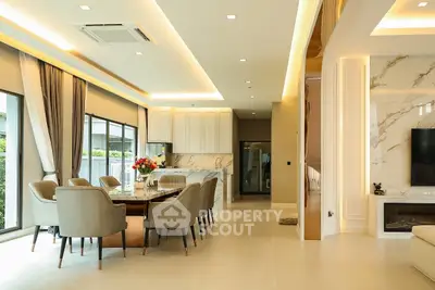 Luxurious open-plan living and dining area with elegant decor and large windows