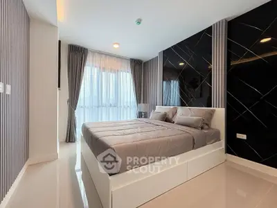 Modern bedroom with sleek design and large windows in a stylish apartment.