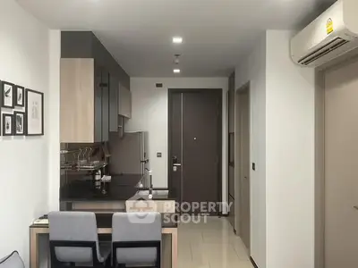 Modern kitchen with sleek design and dining area in a stylish apartment.