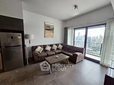 Modern living room with city view, cozy sofa, and sleek decor.